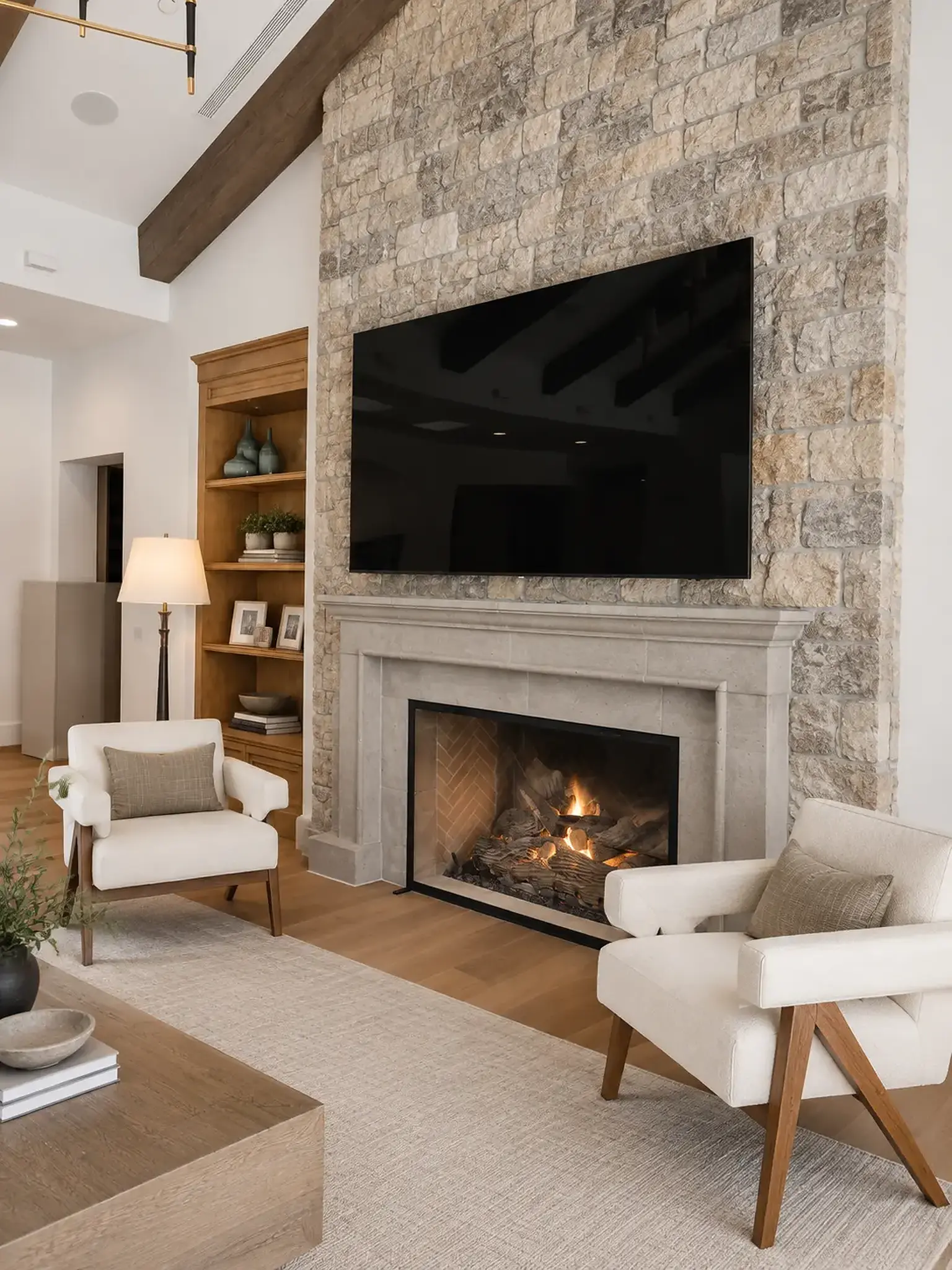 Stone fireplace framed by custom built-in cabinetry