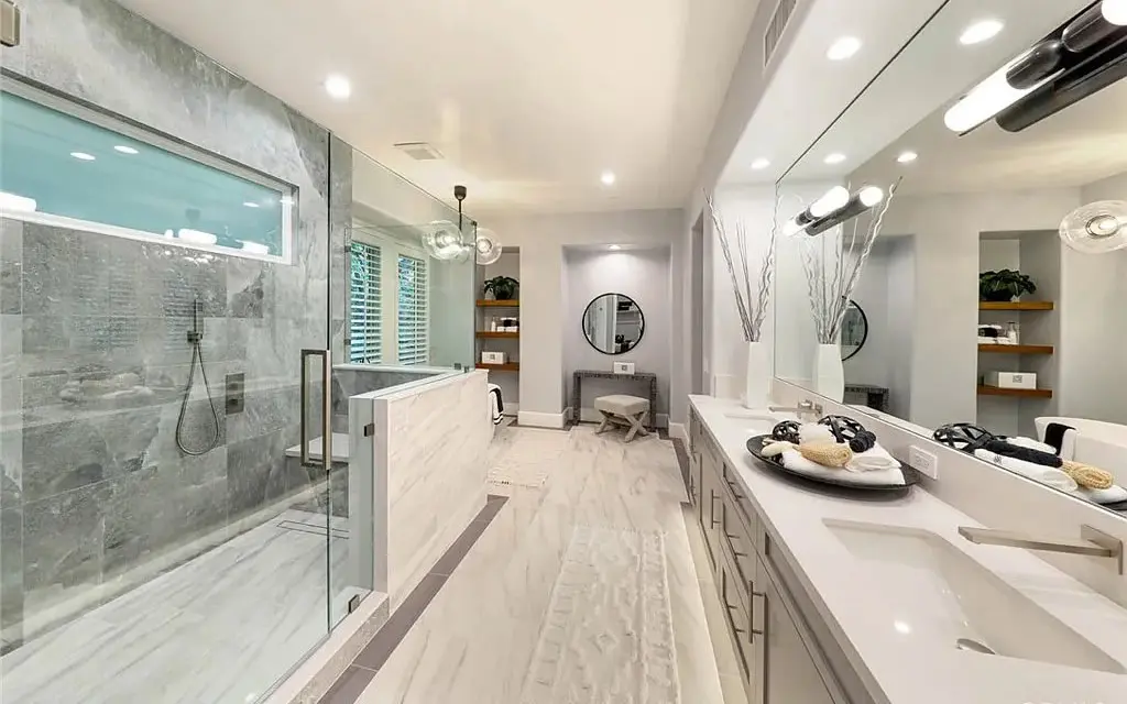 Primary bathroom finished with natural stone tones
